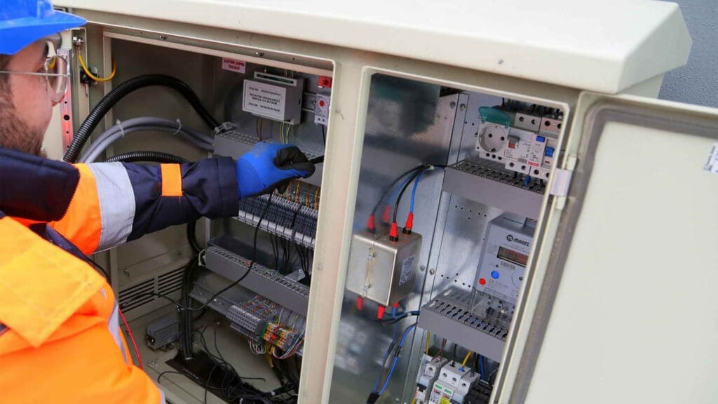 Technician Inspecting Outdoor Electrical Control Panel